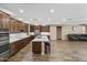 Open kitchen design with stainless steel appliances, a large island, hardwood floors, and abundant storage at 12516 W Mclellan Ct, Glendale, AZ 85307