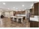 Spacious open kitchen with stainless appliances, a large island and hardwood flooring at 12516 W Mclellan Ct, Glendale, AZ 85307