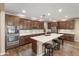 Spacious kitchen features stainless steel appliances, a large island with seating, and lots of cabinets at 12516 W Mclellan Ct, Glendale, AZ 85307