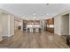 Expansive open kitchen and living space with island seating and rich wood cabinetry at 12516 W Mclellan Ct, Glendale, AZ 85307