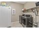 Laundry room with a washer, dryer, shelving, and a freezer at 12516 W Mclellan Ct, Glendale, AZ 85307