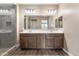 Bright main bathroom featuring double sinks, ample counter space, and a glass-enclosed shower at 12516 W Mclellan Ct, Glendale, AZ 85307