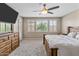 Bright main bedroom with plush carpet, wooden dresser, shutters, and ceiling fan at 12516 W Mclellan Ct, Glendale, AZ 85307