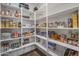 Organized walk-in pantry with lots of shelves and storage solutions to maximize your kitchen space at 12516 W Mclellan Ct, Glendale, AZ 85307