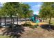 Community playground features a modern playground with a picnic shelter surrounded by mature shade trees at 12516 W Mclellan Ct, Glendale, AZ 85307