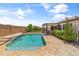 A stunning backyard with a sparkling pool, patio, and lush landscaping for relaxing outdoor living at 12516 W Mclellan Ct, Glendale, AZ 85307
