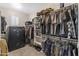 Organized walk-in closet with shelves, hanging rods, and secure storage for clothes and accessories at 12516 W Mclellan Ct, Glendale, AZ 85307