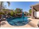 Serene pool and outdoor area with a tranquil waterfall and ample seating at 13629 W San Miguel Ave, Litchfield Park, AZ 85340