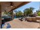 Expansive backyard with a shimmering pool, lounge area, and lush landscaping at 13629 W San Miguel Ave, Litchfield Park, AZ 85340