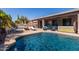 Resort-style backyard featuring a sparkling pool, covered patio, hot tub, and outdoor bar at 13629 W San Miguel Ave, Litchfield Park, AZ 85340