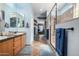 Bathroom with double sinks, wood cabinets, and a glass enclosed shower at 13629 W San Miguel Ave, Litchfield Park, AZ 85340