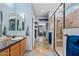 Elegant bathroom with dual sinks, walk-in glass shower, and tiled floor at 13629 W San Miguel Ave, Litchfield Park, AZ 85340