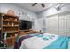 Comfortable bedroom featuring a bed, wooden furniture, ceiling fan, and plenty of space at 13629 W San Miguel Ave, Litchfield Park, AZ 85340
