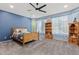 Spacious bedroom with a ceiling fan, light blue walls, and carpet flooring at 13629 W San Miguel Ave, Litchfield Park, AZ 85340