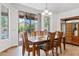Bright dining area with a large table, sliding glass doors to the backyard, and natural light at 13629 W San Miguel Ave, Litchfield Park, AZ 85340