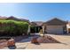 Charming single-story home with a well-manicured front yard and a two-car garage at 13629 W San Miguel Ave, Litchfield Park, AZ 85340