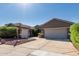 Beautiful home featuring a spacious driveway, desert landscaping, and a tile roof at 13629 W San Miguel Ave, Litchfield Park, AZ 85340