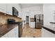 Modern kitchen with stainless steel appliances, granite countertops, and white cabinetry at 13629 W San Miguel Ave, Litchfield Park, AZ 85340