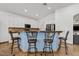 Stylish kitchen featuring white cabinetry, stainless steel appliances, and a breakfast bar with seating at 13629 W San Miguel Ave, Litchfield Park, AZ 85340