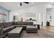 Spacious living room with large sectional sofa, open to kitchen, and bright natural light at 13629 W San Miguel Ave, Litchfield Park, AZ 85340