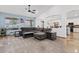 Open living area with neutral tones, a large sectional, and seamless access to the dining area at 13629 W San Miguel Ave, Litchfield Park, AZ 85340