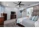 Comfortable bedroom featuring a television and fireplace at 13629 W San Miguel Ave, Litchfield Park, AZ 85340