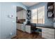 Charming office nook featuring built-in shelves and a desk with natural light perfect for working from home at 13629 W San Miguel Ave, Litchfield Park, AZ 85340