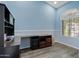 Office room featuring bright blue walls, dark wooden desk, and large window at 13629 W San Miguel Ave, Litchfield Park, AZ 85340
