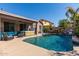 Stunning backyard pool area featuring a hot tub and cascading waterfall feature at 13629 W San Miguel Ave, Litchfield Park, AZ 85340
