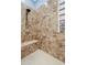Close-up of tiled walk-in shower with glass block window and shower seat at 13629 W San Miguel Ave, Litchfield Park, AZ 85340