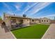 Inviting backyard with artificial grass, outdoor seating, and a built-in grill at 15038 N 22Nd St, Phoenix, AZ 85022