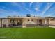 Wide view of the backyard featuring artificial turf, patio and a built in grill at 15038 N 22Nd St, Phoenix, AZ 85022