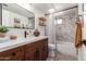 Well-lit bathroom showcases a double vanity, bathtub and shower combo, and modern fixtures at 15038 N 22Nd St, Phoenix, AZ 85022