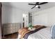 Bright bedroom features carpeted floors, ceiling fan, and closet with a neutral color palette at 15038 N 22Nd St, Phoenix, AZ 85022