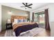Bright bedroom boasts a wooden headboard, stylish ceiling fan, and sliding glass door to the backyard at 15038 N 22Nd St, Phoenix, AZ 85022