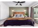 Bright bedroom boasts a wooden headboard, stylish ceiling fan, and slider to backyard at 15038 N 22Nd St, Phoenix, AZ 85022
