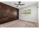 The bedroom is bright with a dark wooden panel, carpeted floors, and natural light at 15038 N 22Nd St, Phoenix, AZ 85022