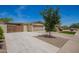View of a single-story home with a driveway, mature landscaping, and two-car garage at 15038 N 22Nd St, Phoenix, AZ 85022