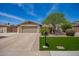 Charming single-story home featuring a well-maintained lawn, mature tree, and a two-car garage at 15038 N 22Nd St, Phoenix, AZ 85022