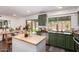 Stylish kitchen with green cabinets, stainless steel appliances, and an island with stool seating at 15038 N 22Nd St, Phoenix, AZ 85022