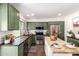 Well-lit kitchen with green cabinets, stainless steel appliances, and a functional island at 15038 N 22Nd St, Phoenix, AZ 85022