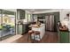 Modern kitchen featuring green cabinetry, stainless steel appliances, and a center island at 15038 N 22Nd St, Phoenix, AZ 85022