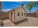 Backyard shed with a neutral paint job and surrounded by decorative rock at 15038 N 22Nd St, Phoenix, AZ 85022