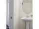 Bathroom featuring a white pedestal sink and a round mirror at 15252 N 100Th St # 1147, Scottsdale, AZ 85260