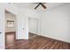 Bedroom featuring wood-look floors, a closet with mirrored doors, and a ceiling fan at 15252 N 100Th St # 1147, Scottsdale, AZ 85260