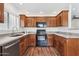 Well-appointed kitchen featuring dark appliances, granite countertops, and dark wood cabinets at 15252 N 100Th St # 1147, Scottsdale, AZ 85260