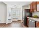 Bright eat-in kitchen with stainless steel appliances, granite counters, and a built-in banquette at 15252 N 100Th St # 1147, Scottsdale, AZ 85260