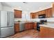 Traditional kitchen with stainless steel appliances, granite counters, and wood cabinets at 15252 N 100Th St # 1147, Scottsdale, AZ 85260