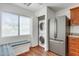 Kitchen with bench seating, stainless fridge, and included washer/dryer at 15252 N 100Th St # 1147, Scottsdale, AZ 85260