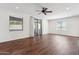 Bright living room with wood floors, ceiling fan, recessed lights, and large windows at 15252 N 100Th St # 1147, Scottsdale, AZ 85260